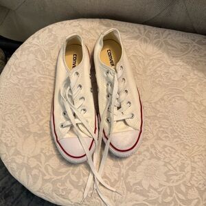 Converse White Sneakers with Red Accents.